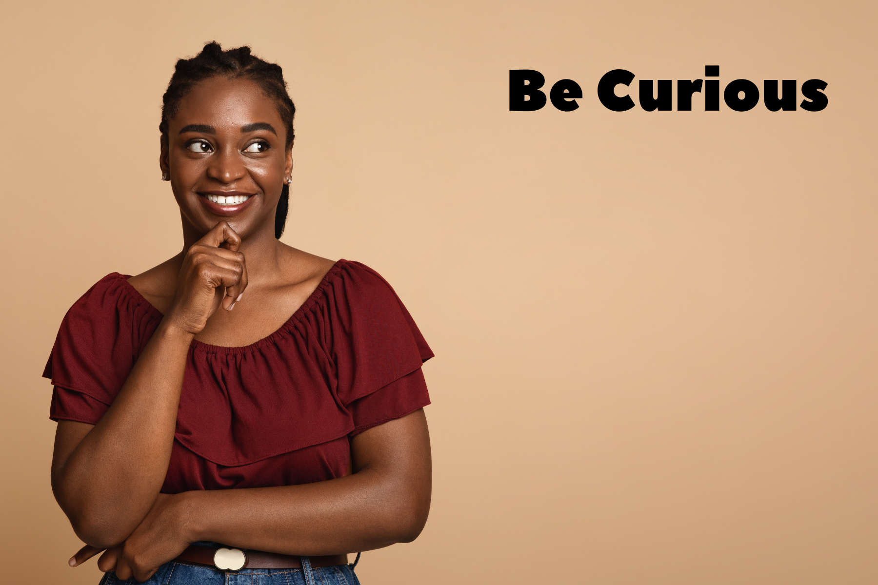 Woman in t-shirt grabbing her chin and smiling - text states 'be curious'