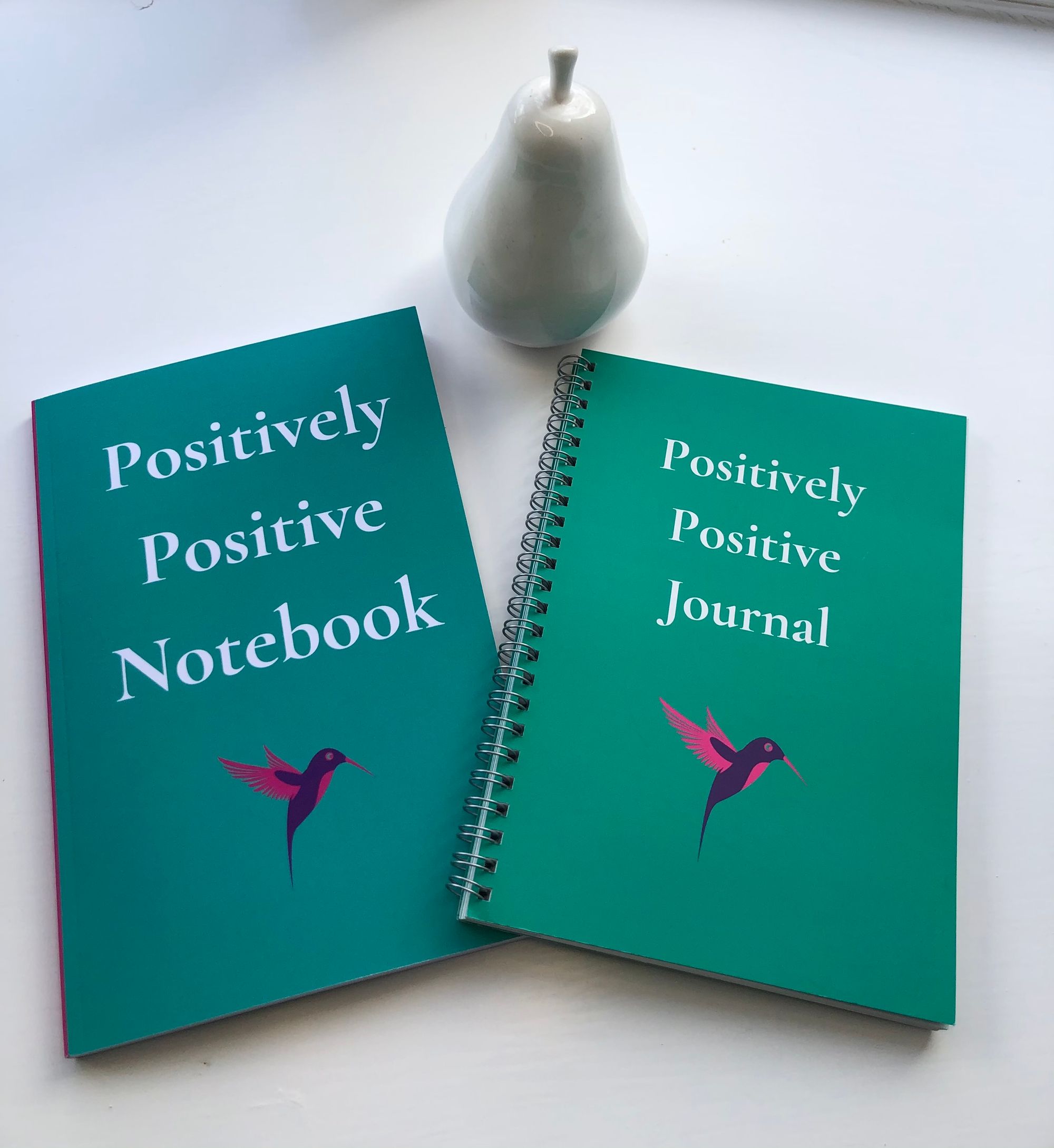 Green notebook and guided journal with purple and pink hummingbird motif